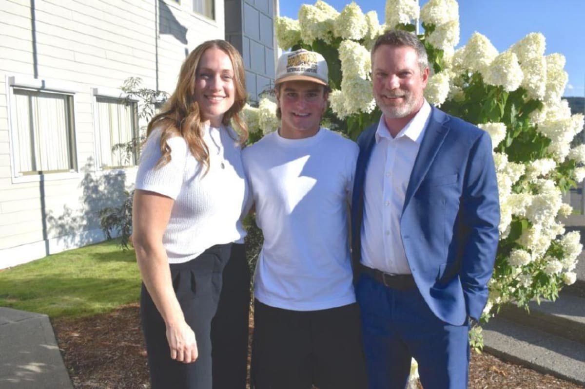 Nurse Kayla Lucas stands with hockey player Dawson Knackstedt and physiotherapist Tyler Judd