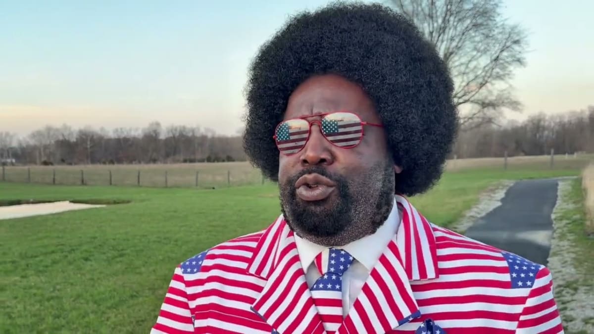 Rapper Afroman wearing American flag suit celebrating legal victory over wrongful police raid lawsuit