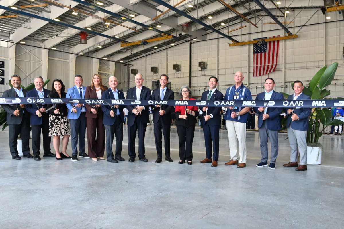Ribbon cutting ceremony with officials and executives at new AAR aircraft maintenance facility in Miami