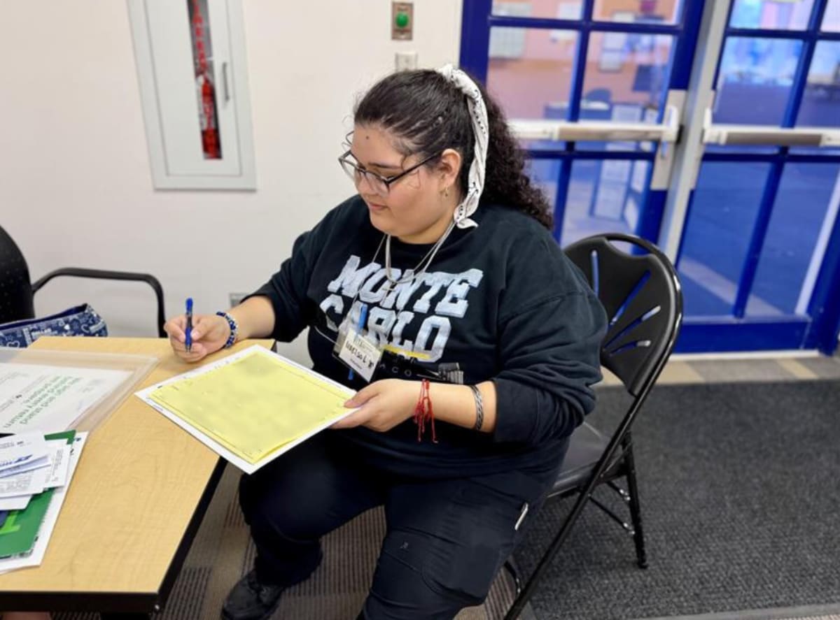 South Texas College student volunteers helping community members prepare tax returns at VITA program site