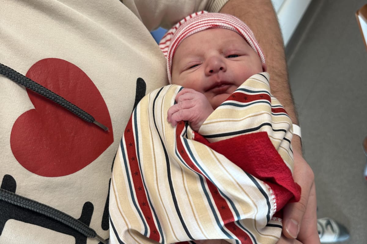Handmade patriotic quilt in red white and blue folded on hospital blanket