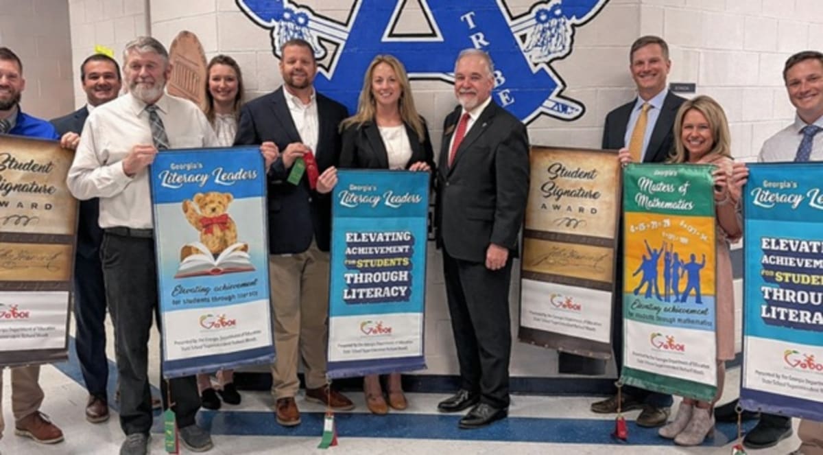 Georgia students and teachers celebrating academic achievement awards at elementary school assembly