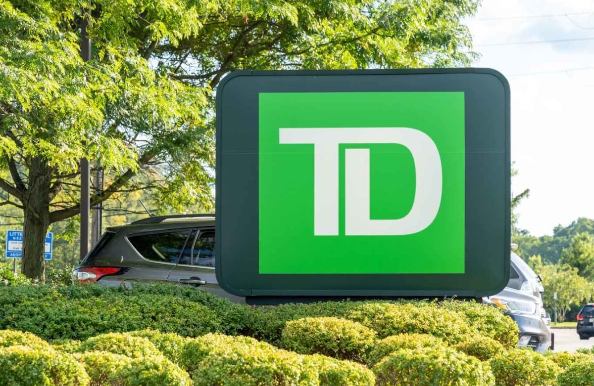 Diverse family smiling together in front of their home, representing housing stability and community support