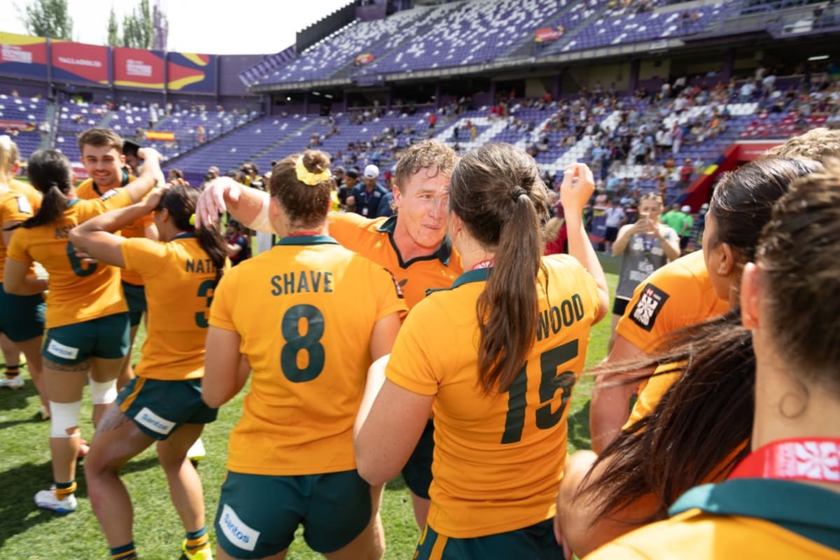 Australian men's and women's rugby sevens teams celebrating together after dual championship victories in Spain