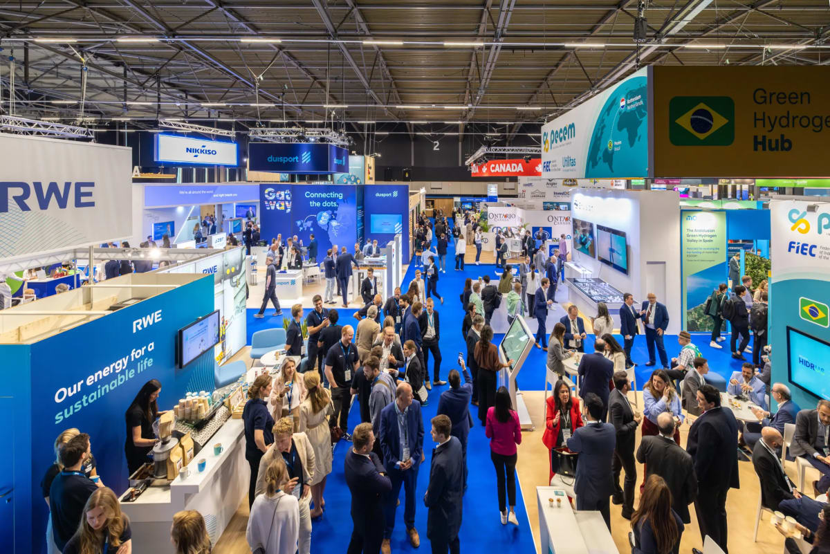 ** Chilean delegation members at World Hydrogen Summit exhibition in Rotterdam Netherlands discussing green energy projects