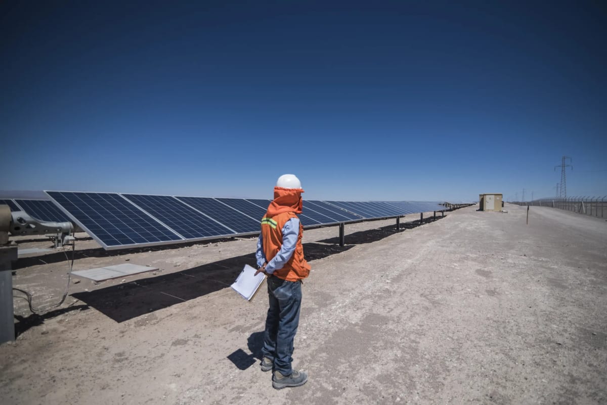 ** Solar panels installed across Chile's sun-drenched Atacama Desert landscape for renewable energy generation