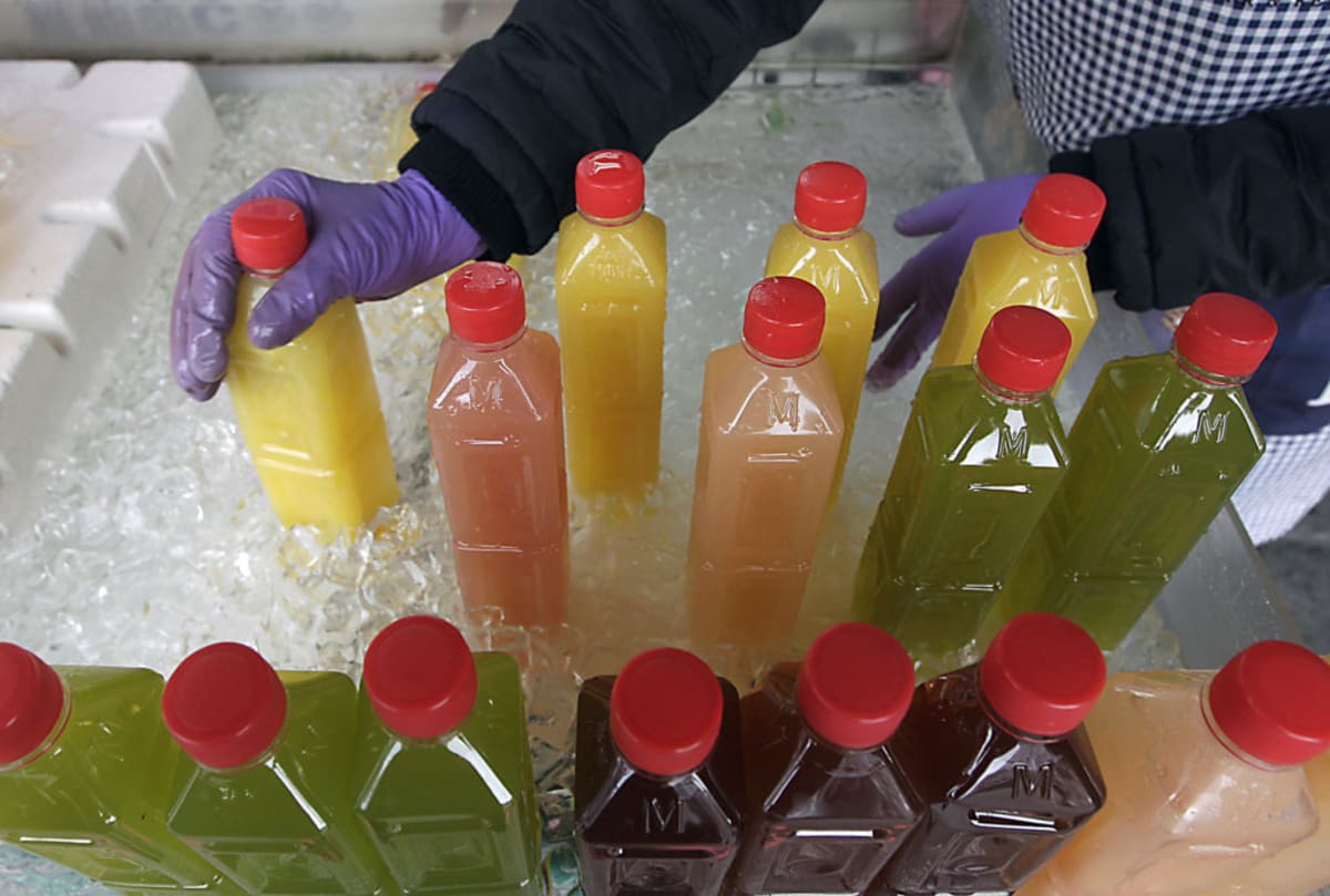 Person drinking clear water from glass, representing natural healthy hydration for body detoxification