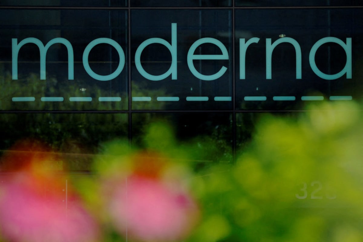 Medical researcher examining cancer cells under microscope in modern laboratory setting