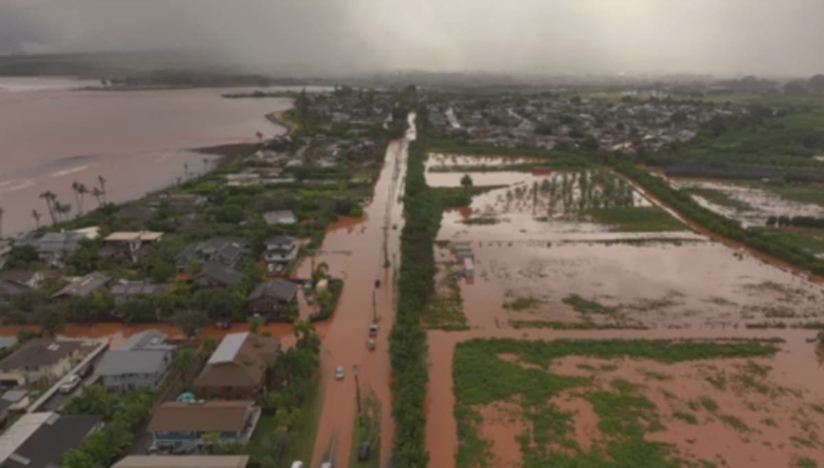 Honolulu firefighters navigating flooded streets during storm rescue operations on Oahu