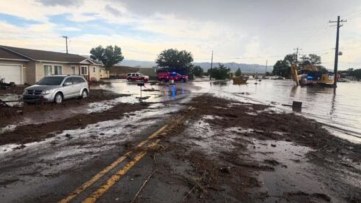 Firefighter in water rescue gear performing swift water rescue operation during storm