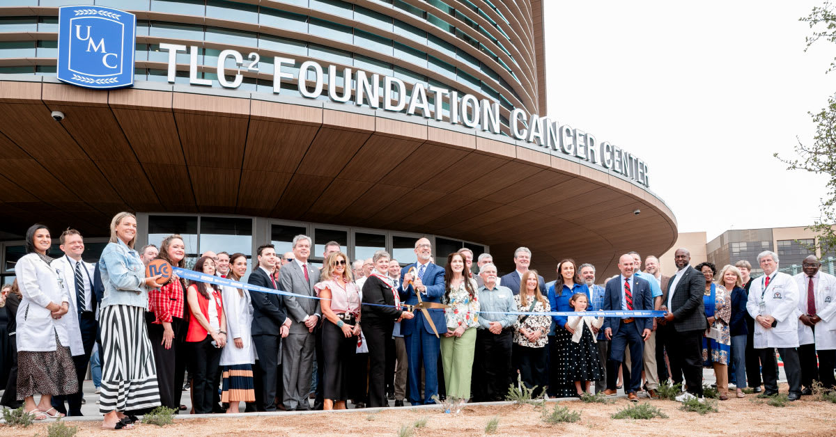 Modern medical facility exterior with glass windows and signage for UMC cancer center in Lubbock Texas