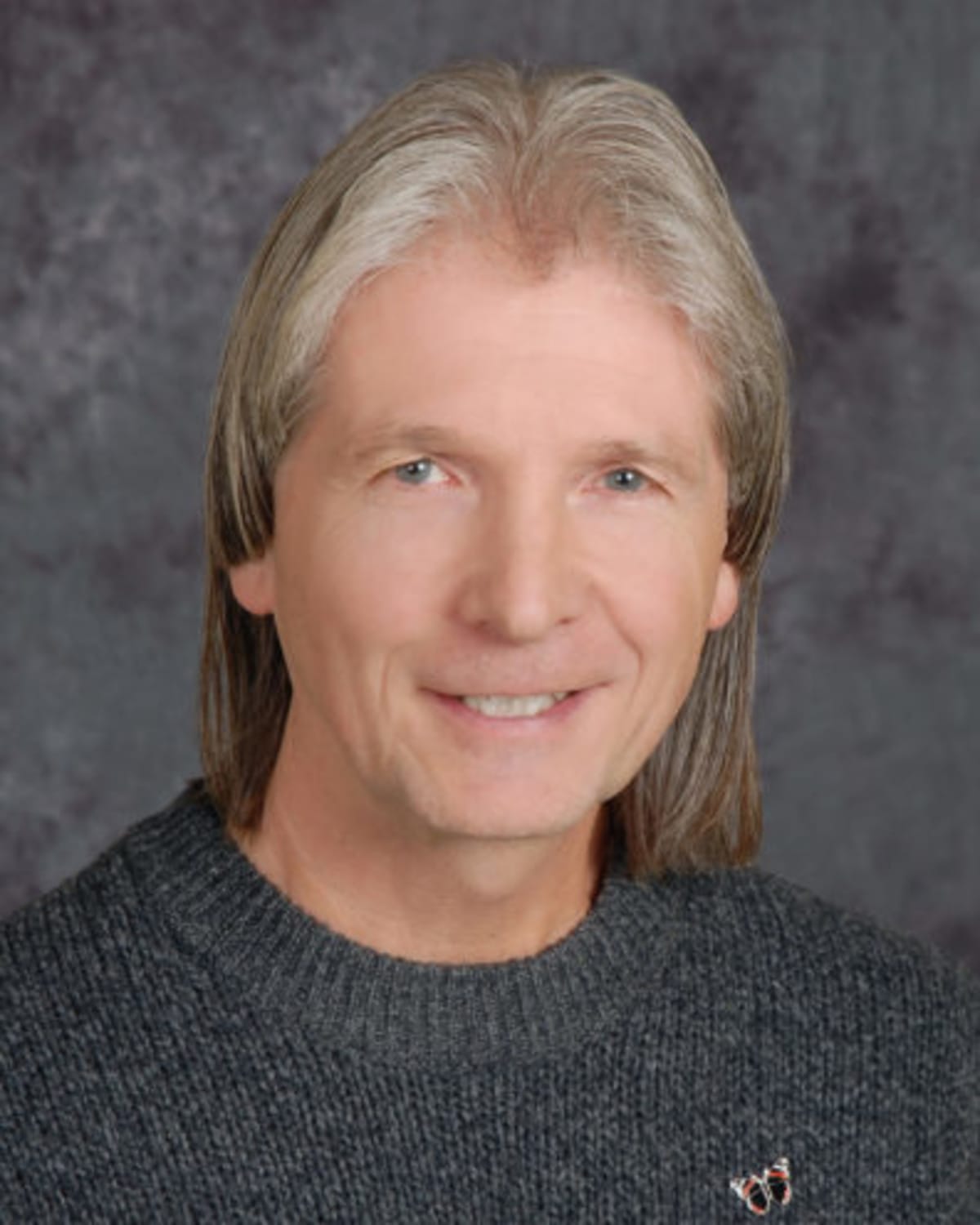 Monarch butterfly with tiny solar-powered tracking tag attached to its orange and black wing