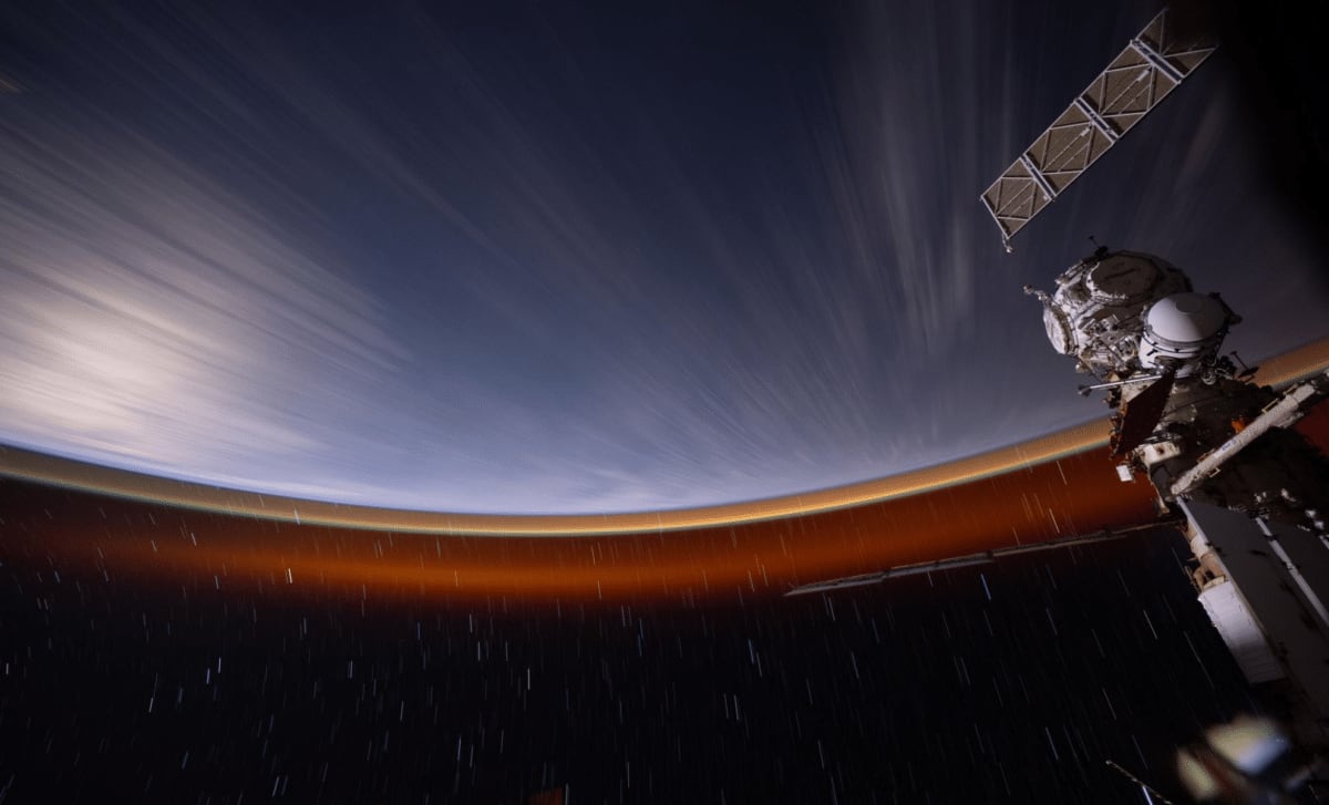 NASA astronaut in white spacesuit working outside the International Space Station during solar array preparation