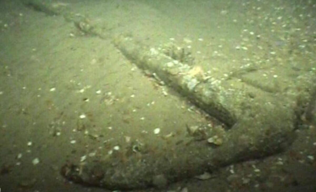 Ancient wooden and iron Roman anchor resting on ship deck after recovery from North Sea