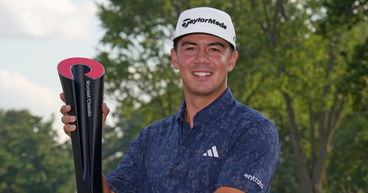 Michael Thorbjornsen holding the Rocket Classic championship trophy at Detroit Golf Club