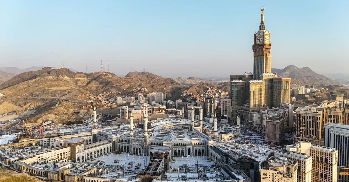 Aerial view of Makkah city skyline with modern hotels surrounding the sacred mosque complex
