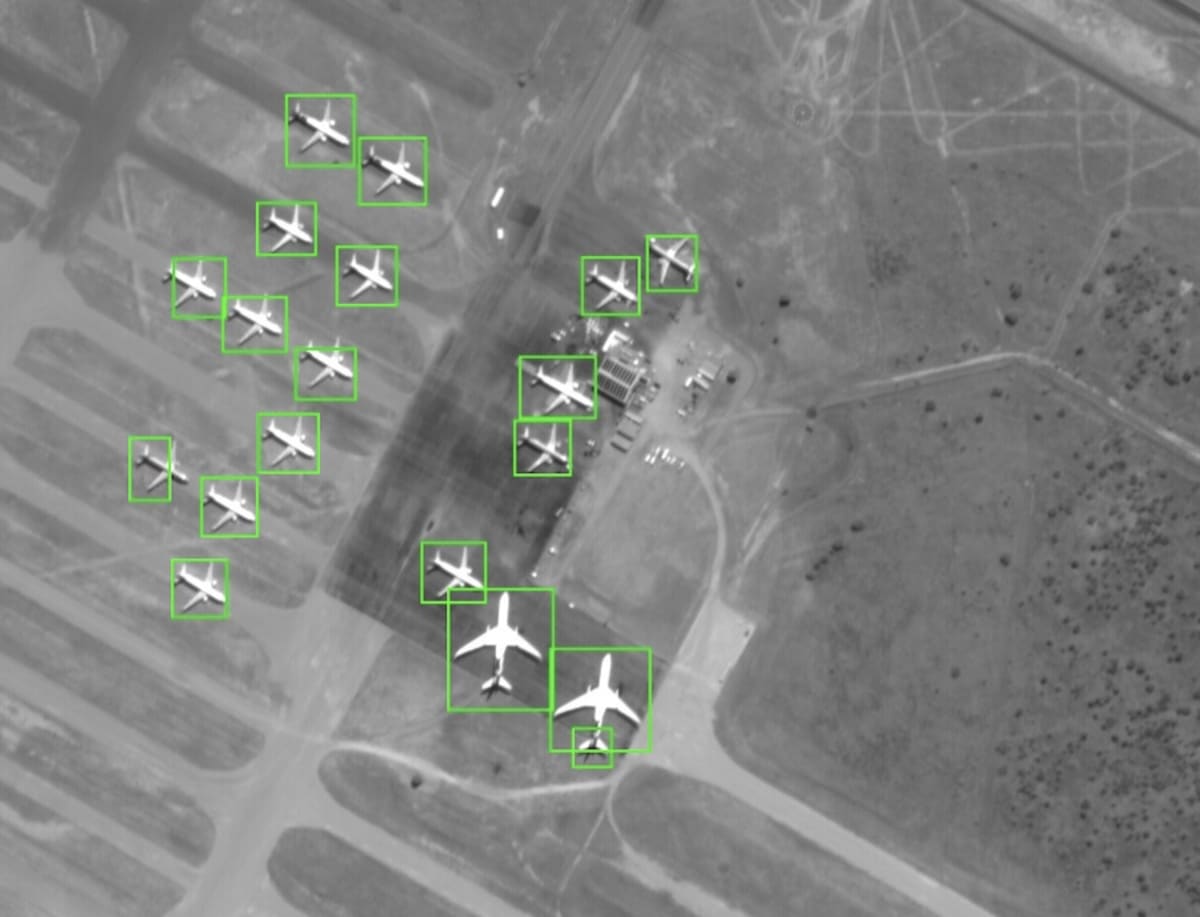 Satellite orbiting Earth with digital AI processing graphics showing real-time object detection capability