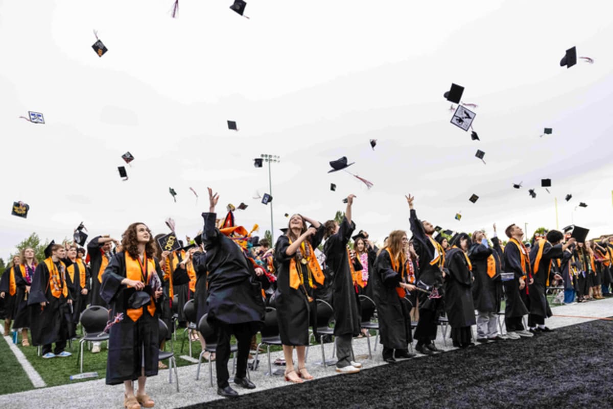 Blaine High School Class of 2026 seniors tossing graduation caps in celebration at Borderite Stadium