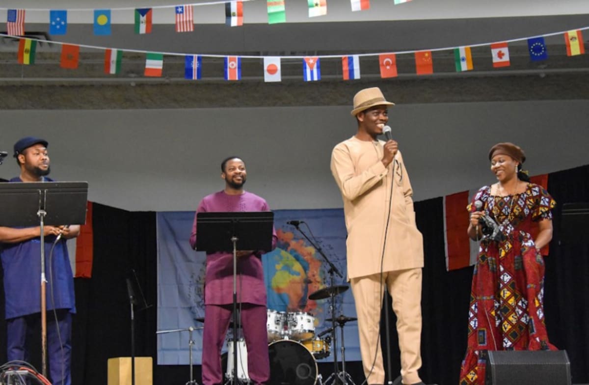 Women gathering together at community drop-in centre fundraising event with musical performances