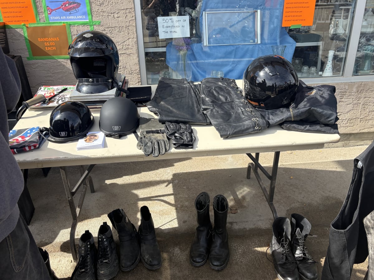 Tubs of Harley Davidson branded clothing and gear displayed at outdoor fundraiser sale
