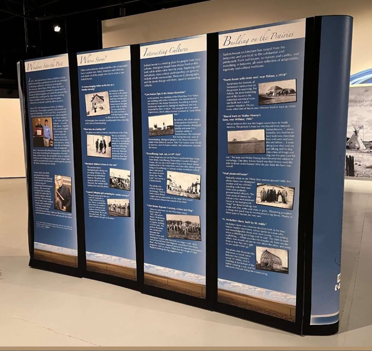 Museum gallery with Indigenous flags, educational displays, and orange shirt decorations honoring residential school survivors