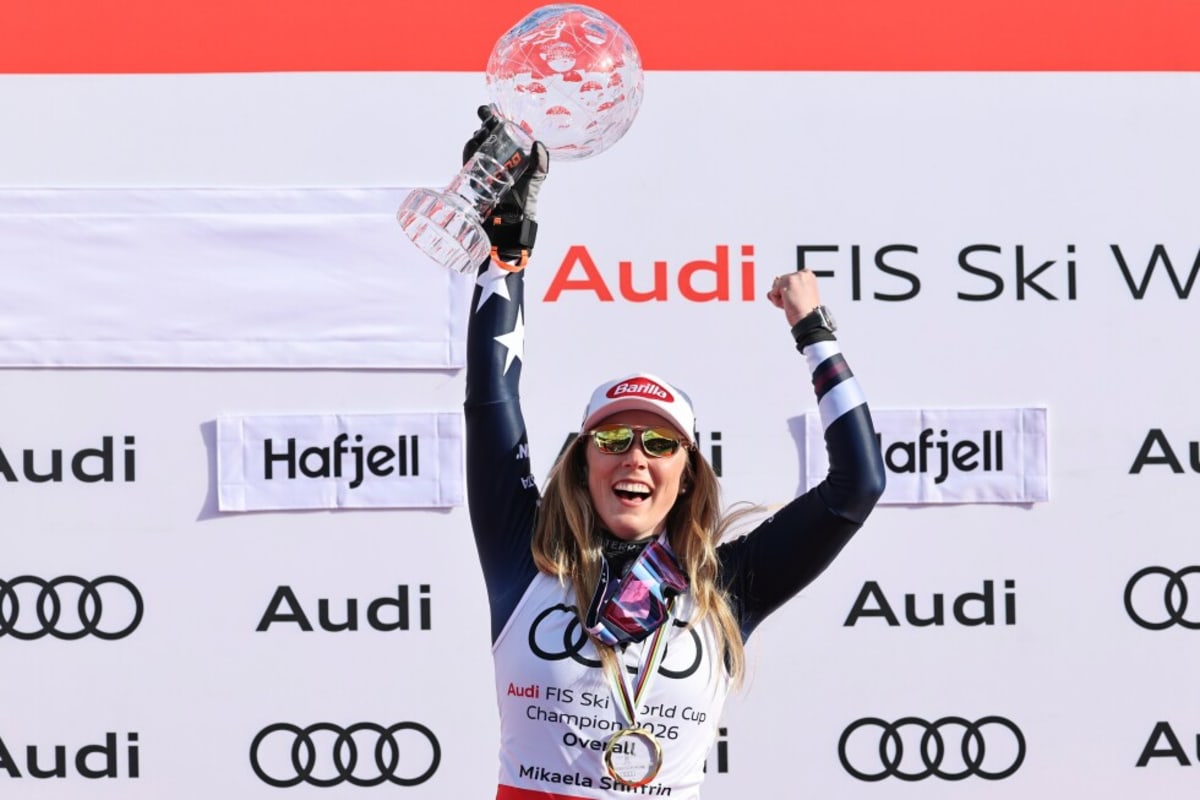 ** Mikaela Shiffrin celebrating on podium after winning her sixth overall World Cup skiing championship
