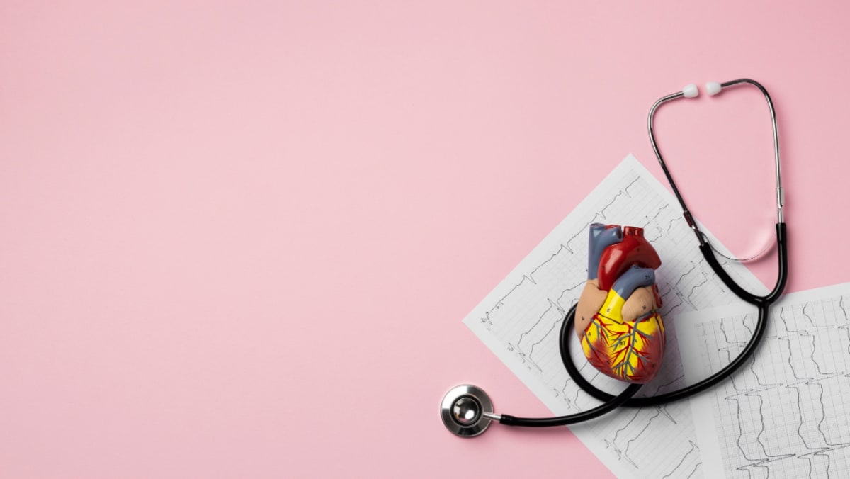 Medical professional reviewing electrocardiogram heart rhythm data on computer screen with privacy protection symbols
