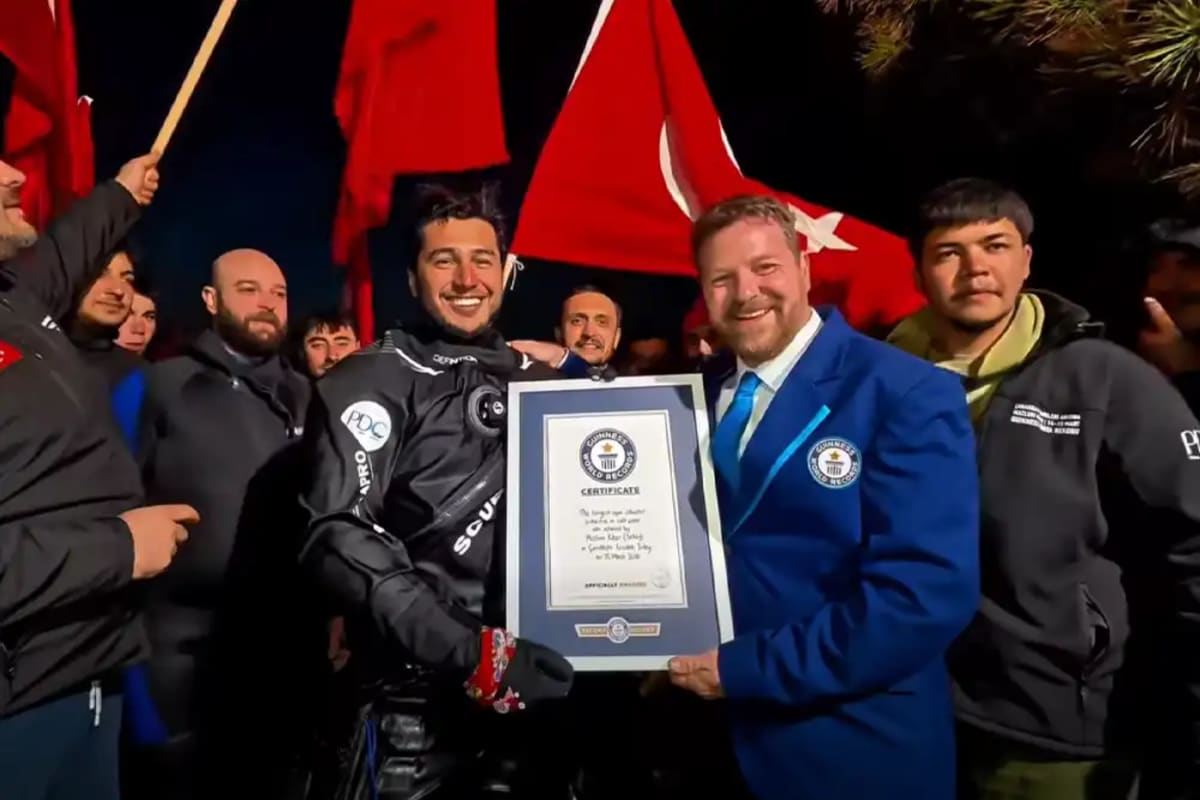 Turkish scuba instructor Mazlum Kibar receiving his Guinness World Records certificate for longest cold water dive