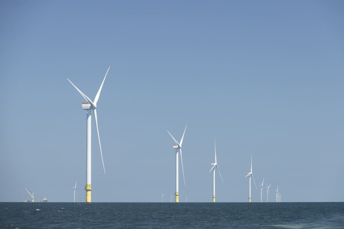 Offshore wind turbines standing in ocean waters generating clean electricity for New England homes
