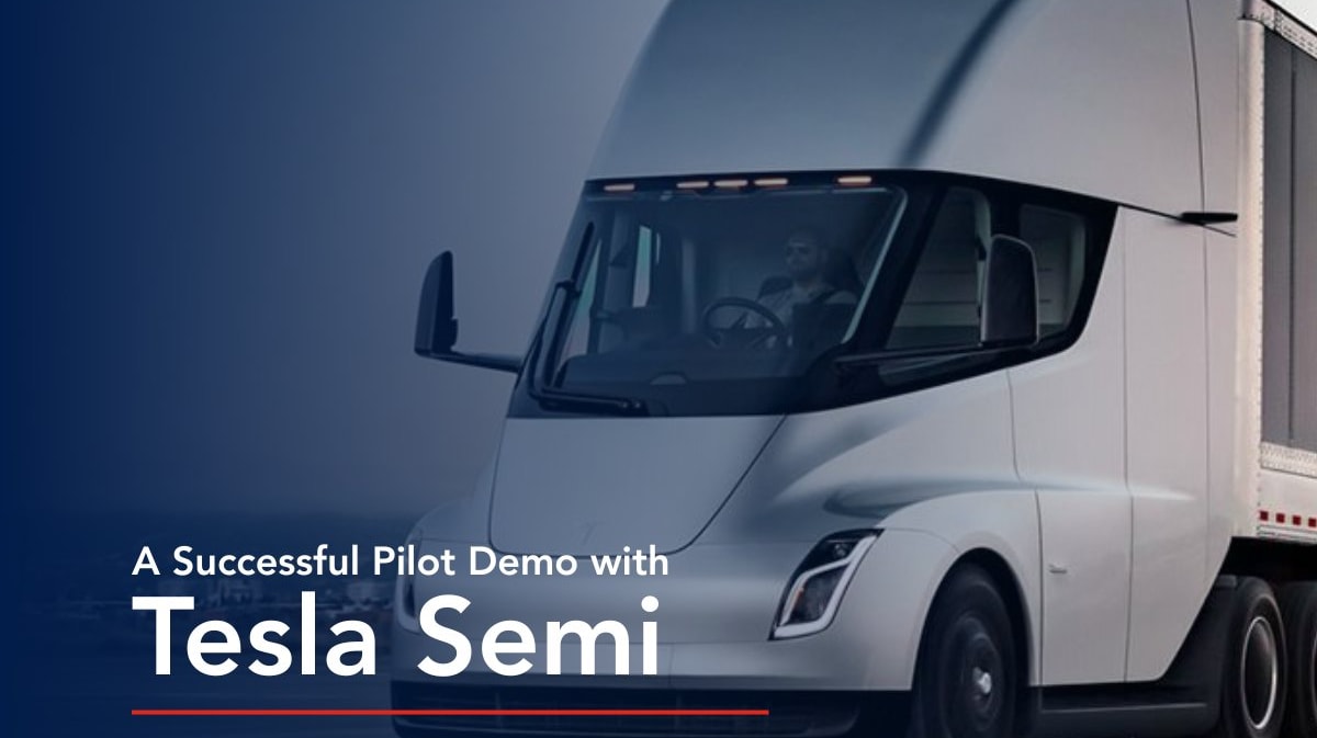 White Tesla Semi electric truck driving on highway carrying freight cargo