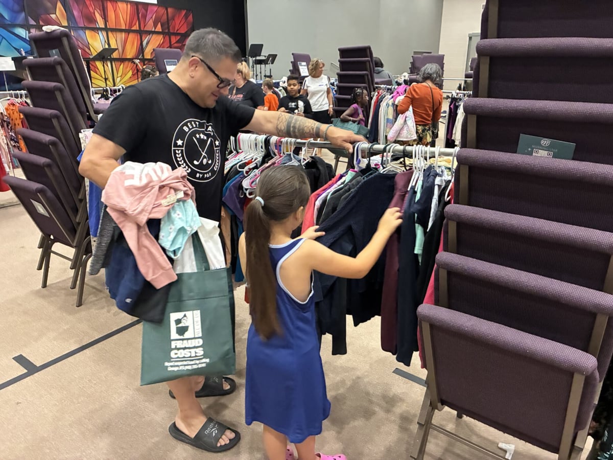 Volunteers organizing donated school supplies and clothing for Geauga County families at Morning Star Friends Church