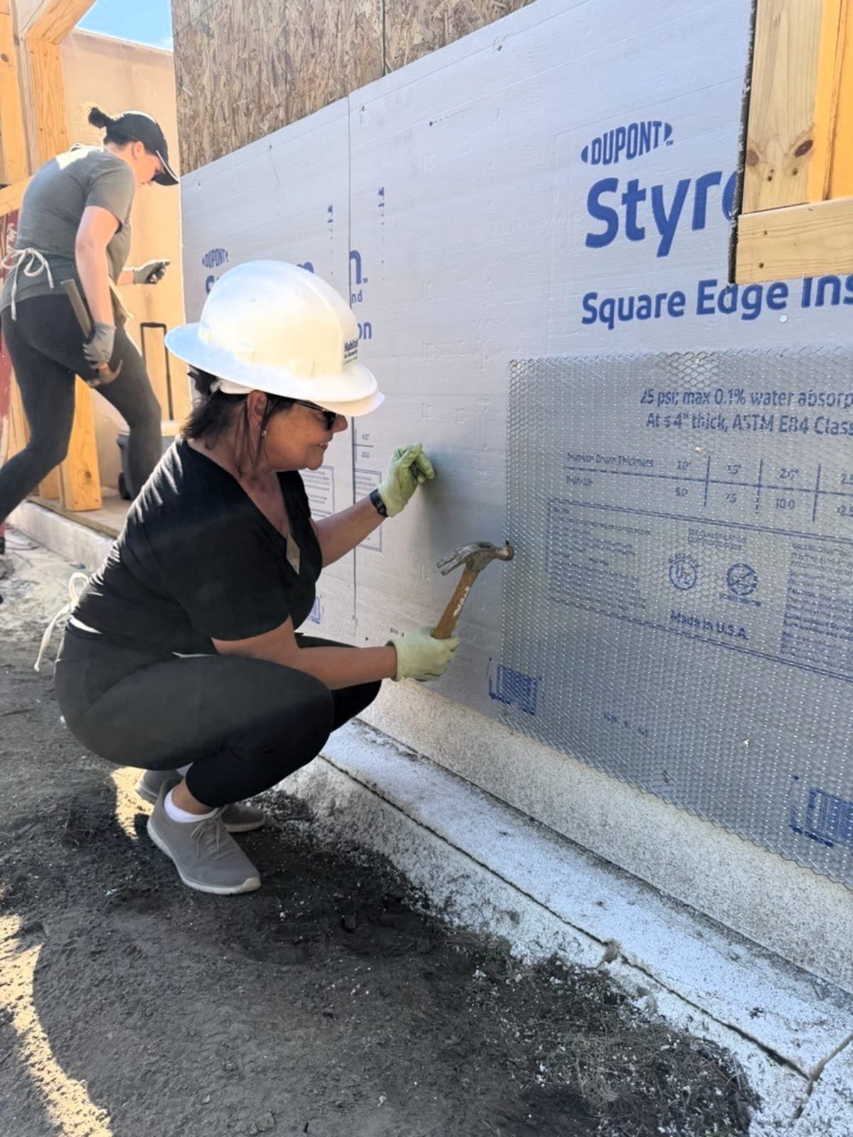 Volunteers working together on residential construction at Habitat for Humanity build site in Southfield, Michigan