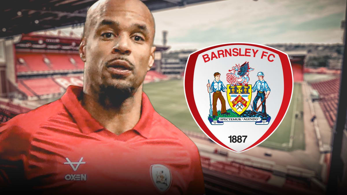 ** David McGoldrick in red Barnsley jersey celebrating a goal on the football pitch