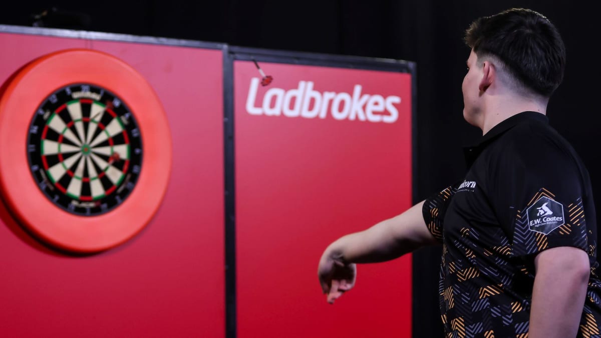 Young darts player Henry Coates celebrating his first professional tournament victory in Germany