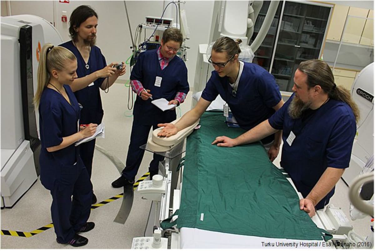 Medical professionals and business developers collaborating together in modern Finnish hospital setting