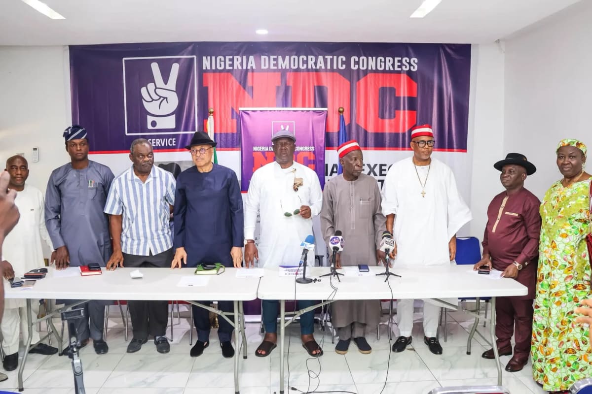 Nigerian political leaders shaking hands at reconciliation committee inauguration ceremony