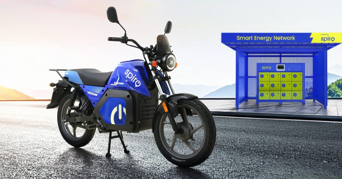 Electric motorcycle rider at battery swapping station in African city with modern charging infrastructure