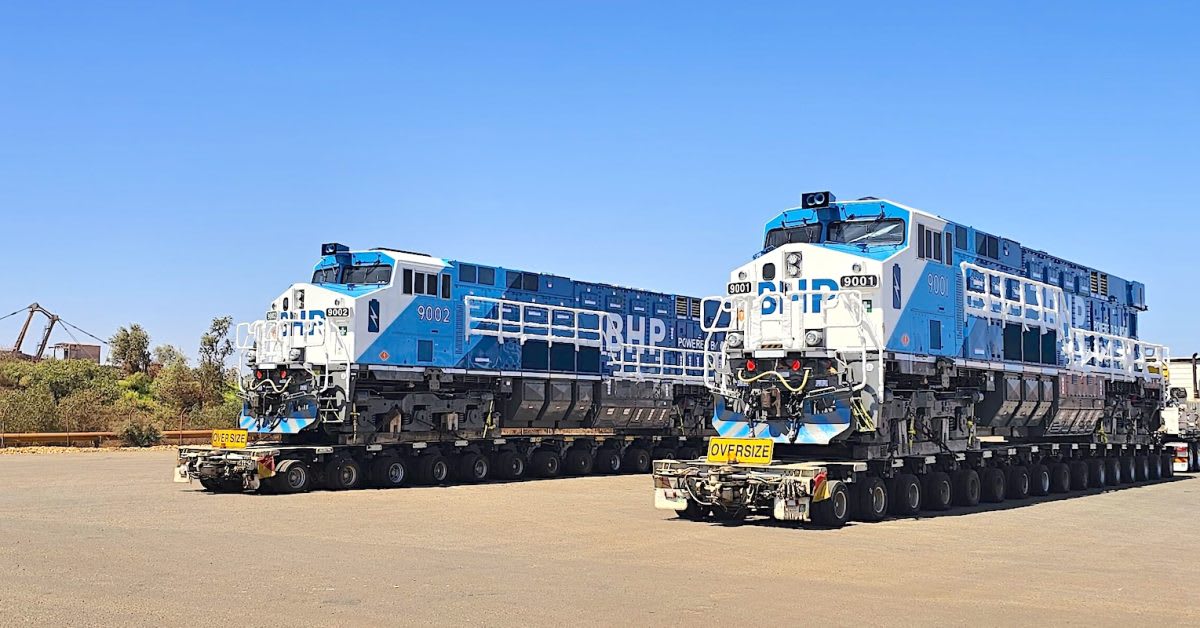 Large battery-powered Wabtec FLXDrive locomotive on rails in Australian desert mining operation