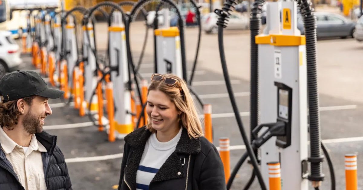 Multiple electric vehicle charging plugs mounted at modern public charging station with power cables