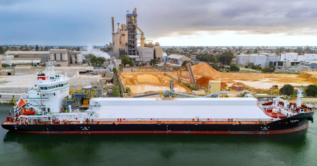 Large gray cargo ship MV Yampu sailing through calm blue waters off Australian coast