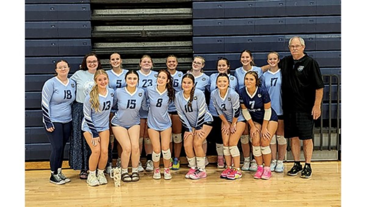 ** Hampton Lady Bulldogs volleyball team celebrates together on court after historic five-set victory