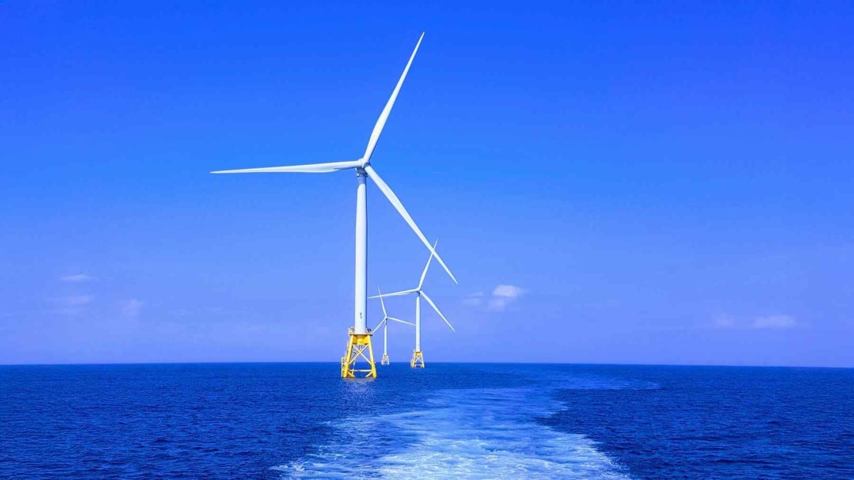 Offshore wind turbines rising from ocean waters off Rhode Island coast generating renewable electricity