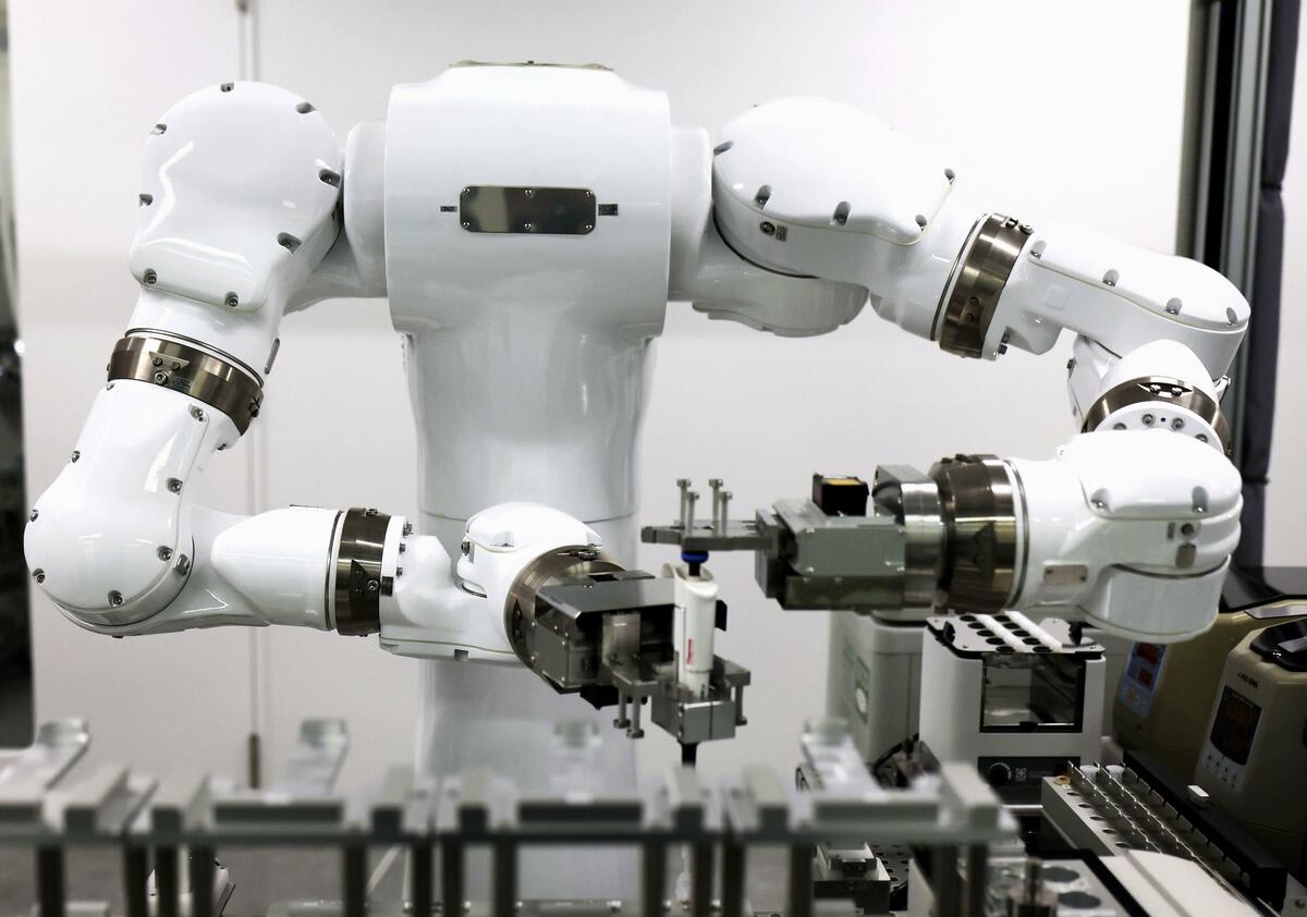 ** Robotic arms conducting scientific experiments autonomously in modern unmanned laboratory in Japan