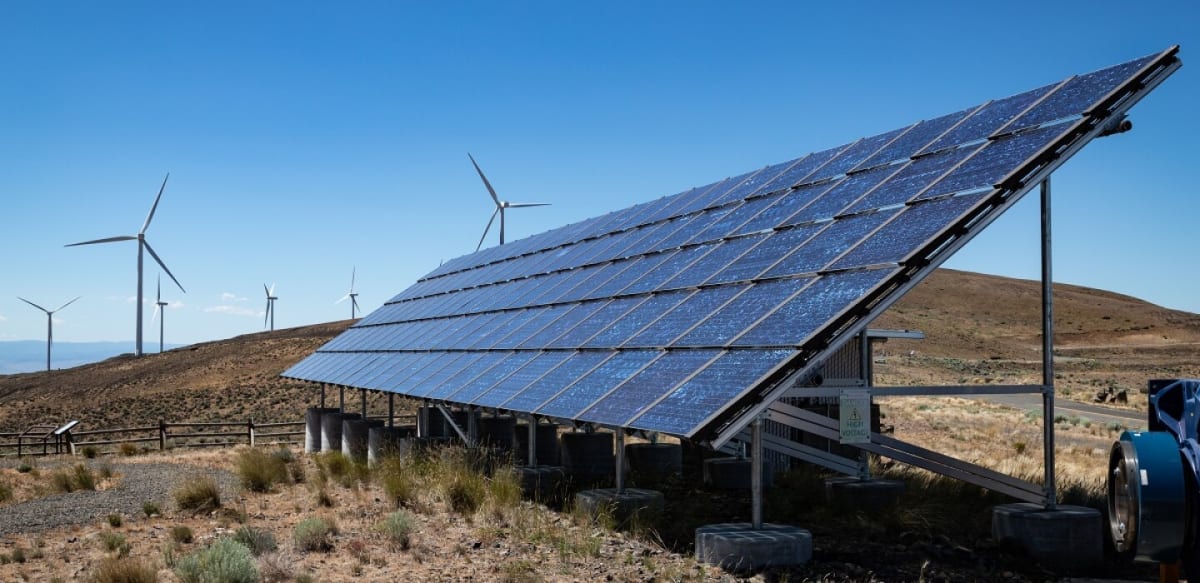 Wind turbines and solar panels at renewable energy facility in wide open Texas landscape