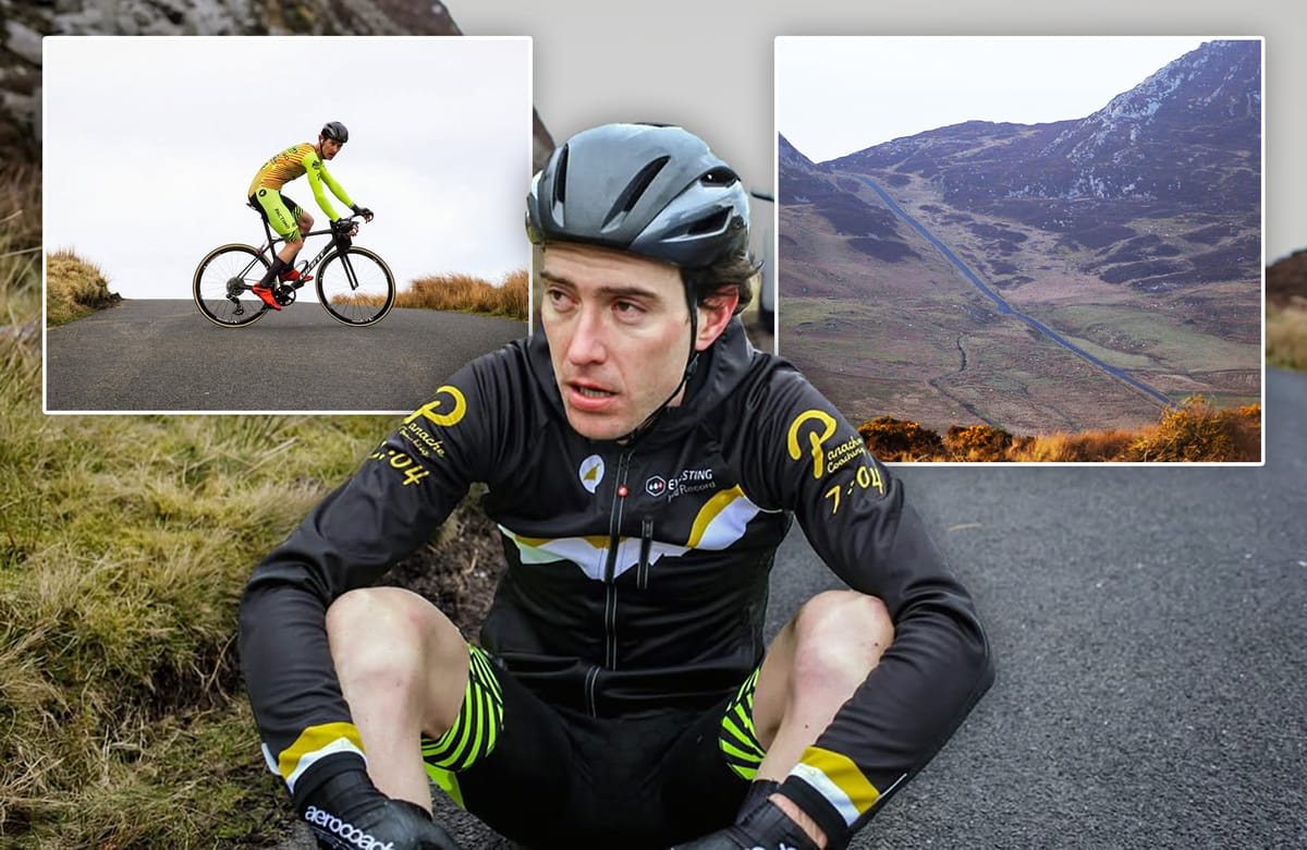Cyclist climbing steep mountain road on Mamore Gap in Ireland during Everesting world record attempt