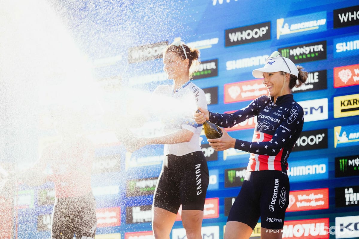 Mountain biker Savilia Blunk racing through dirt trail on cross-country course