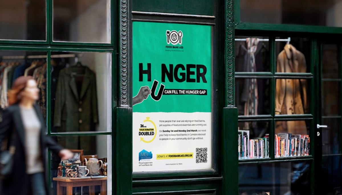 Creative poster showing letter U filling gap in word hunger for London food bank campaign