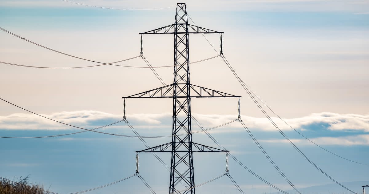 Wind turbines and solar panels generating renewable electricity across British countryside landscape