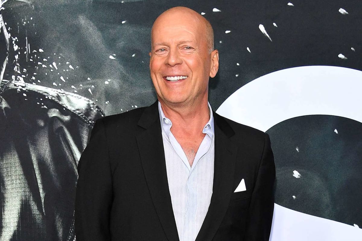 Bruce Willis embracing daughter Tallulah while holding son-in-law Justin Acee's hand at Idaho wedding