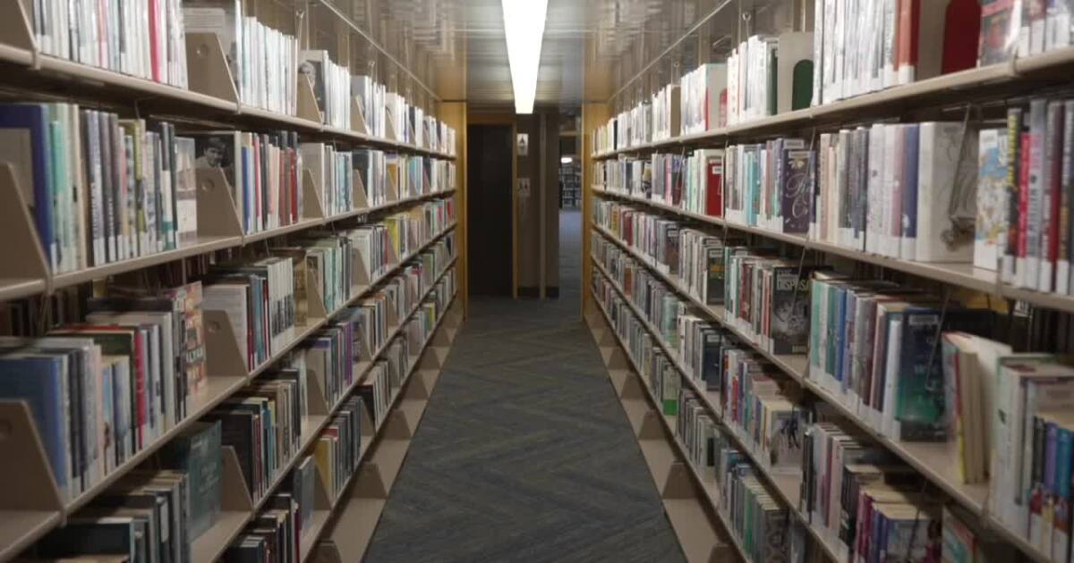 Library volunteer organizing books on shelves at Kern County Library branch in California